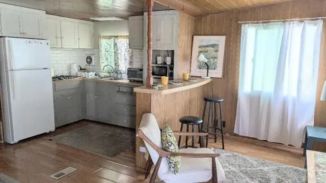 a kitchen with refrigerator and cabinets
