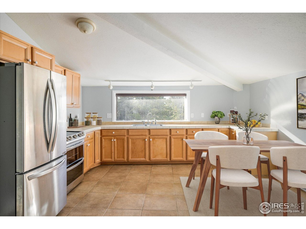 15 Hardscrabble Road Golden, CO 80403 - Photo 14 of 50 a kitchen with a refrigerator a table and chairs