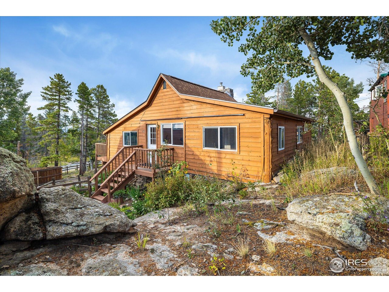 15 Hardscrabble Road Golden, CO 80403 - Photo 6 of 50 a view of a yard in front of a house with large tree