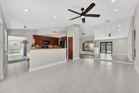 a view of a kitchen with a sink and a refrigerator