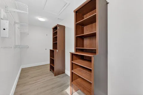 a view of walk in closet with empty racks
