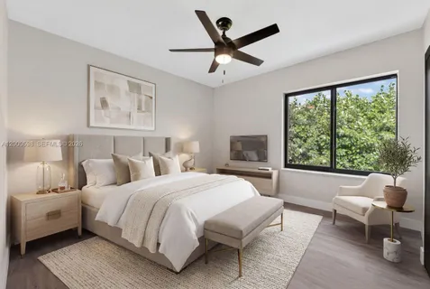 a bedroom with a large bed and a window