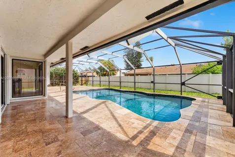 a view of a swimming pool with a lounge chairs