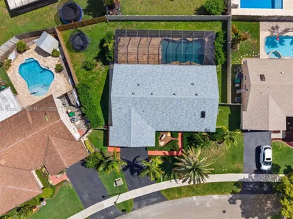 an aerial view of a house with a yard
