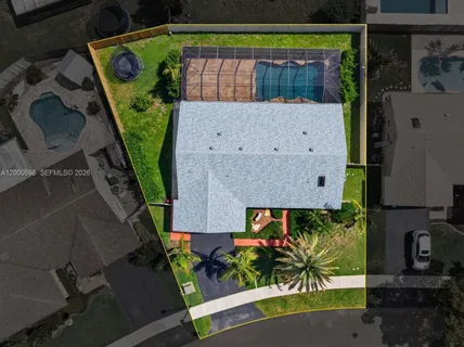an aerial view of a house with a yard