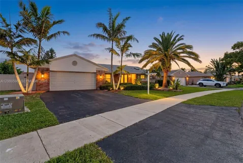 a view of a house with palm trees