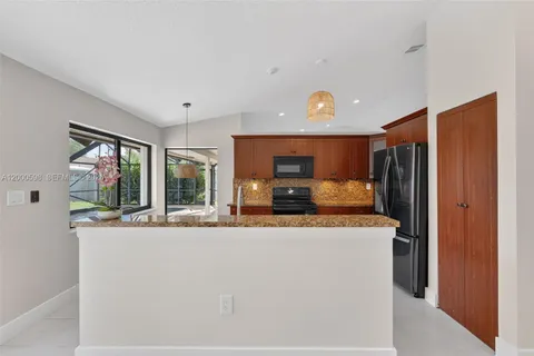 a kitchen with stainless steel appliances granite countertop a refrigerator and a stove