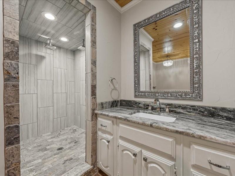 1072 Chapman Road Crawford, TX 76638 - Photo 21 of 39 a bathroom with a granite countertop sink vanity and mirror