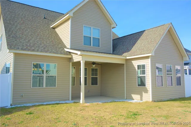 a view of house with backyard of house