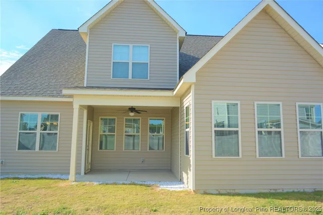 a view of house with backyard of house