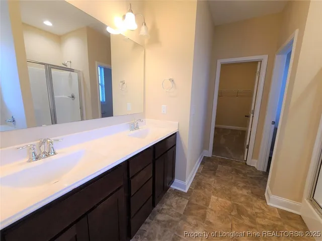 a bathroom with a sink a mirror and a shower