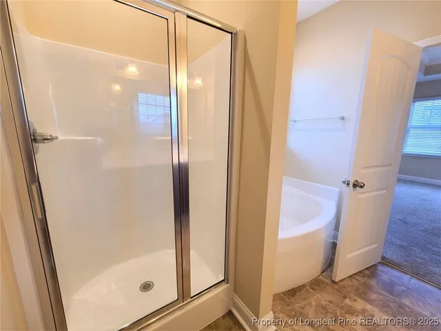 a bathroom with a bathtub and shower