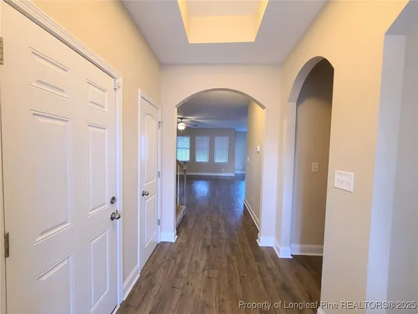 a view of a hallway and wooden floor