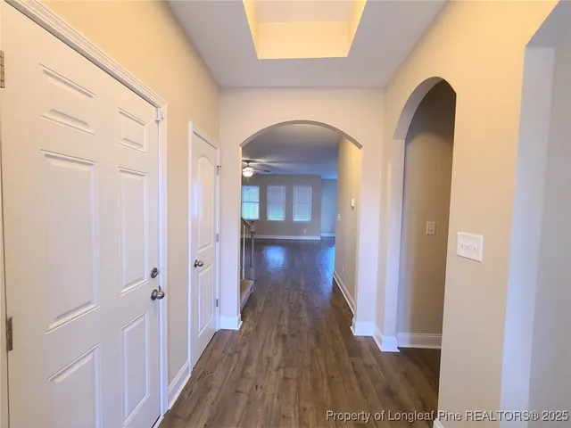 a view of a hallway and wooden floor