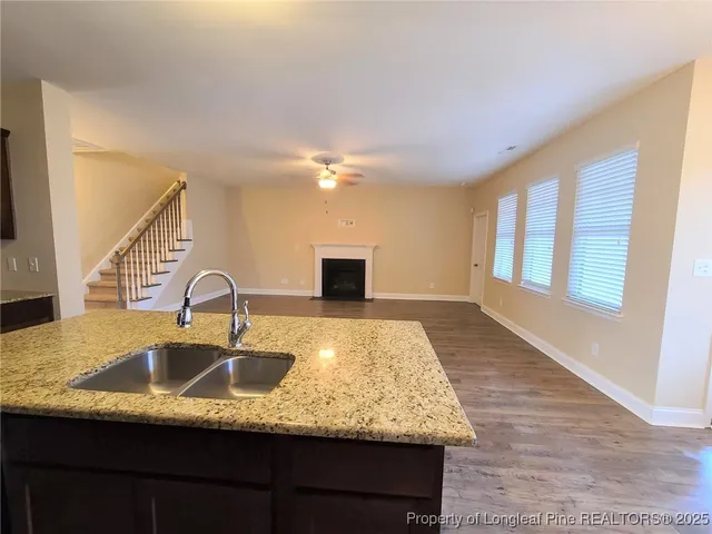 a kitchen with kitchen island a sink appliances and a counter space