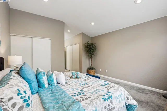 a spacious bathroom with a granite countertop sink a toilet a mirror and shower