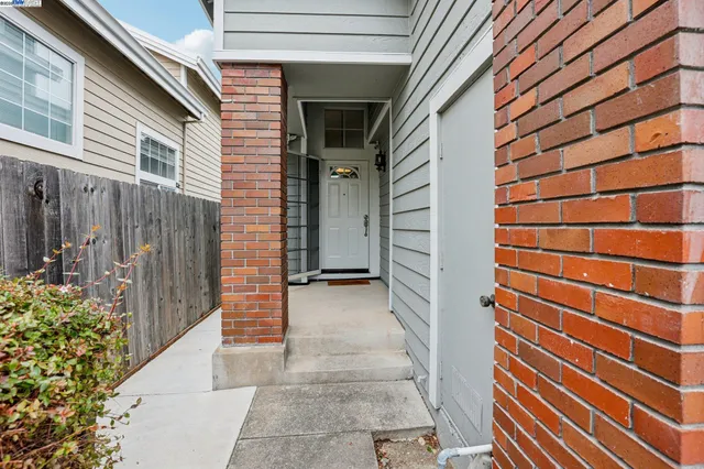 a view of a house with a door and wooden walls