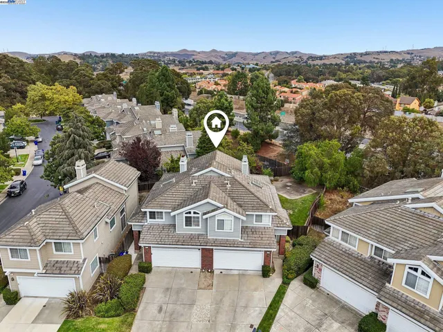 an aerial view of a house with a yard and potted plants