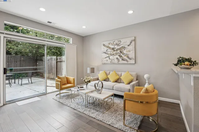 a living room with furniture and a kitchen view