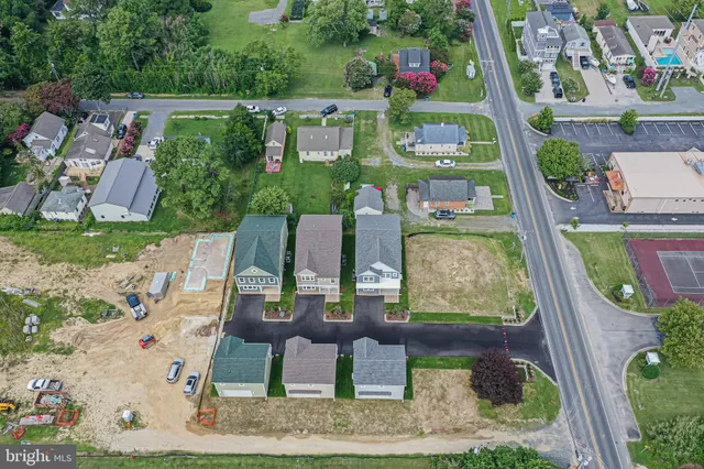 an aerial view of a house with a yard basket ball court and outdoor seating
