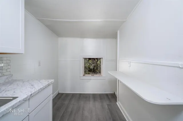 a hallway with a wooden floor and entryway