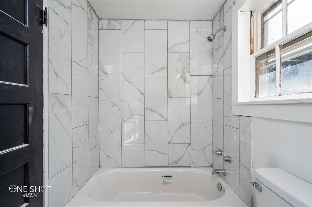 1909 Highland Avenue Abilene, TX 79605 - Photo 23 of 23 a bathroom with a bathtub and a shower