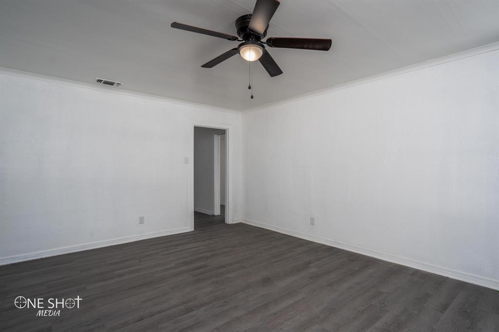 1909 Highland Avenue Abilene, TX 79605 - Photo 3 of 23 a view of an empty room with wooden floor
