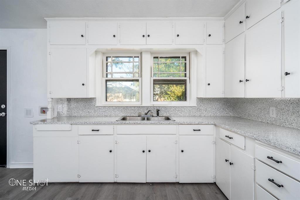 1909 Highland Avenue Abilene, TX 79605 - Photo 6 of 23 a kitchen with white cabinets and window
