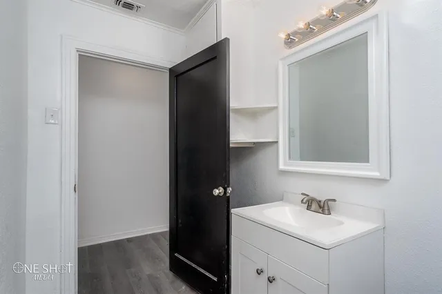a bathroom with a sink toilet and vanity