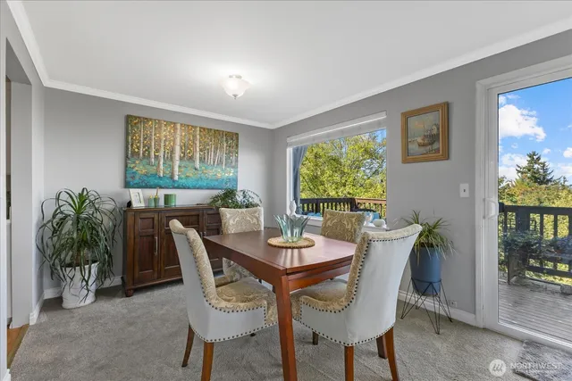 a view of a dining room with furniture and window