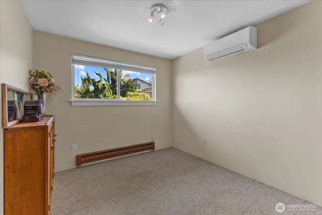 a view of room with window and wooden floor