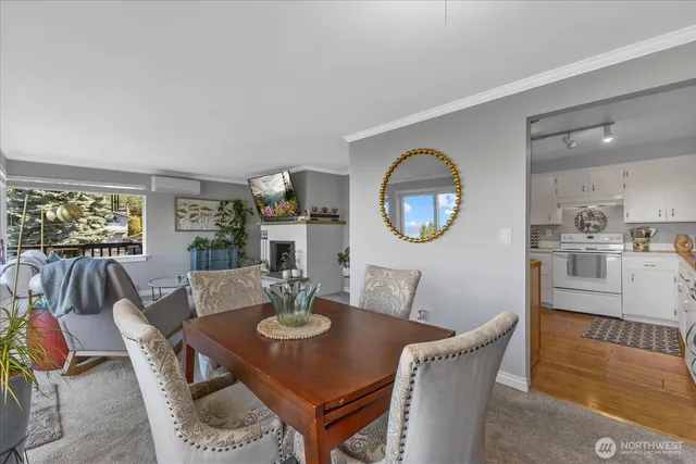 a view of a dining room with furniture and a large window