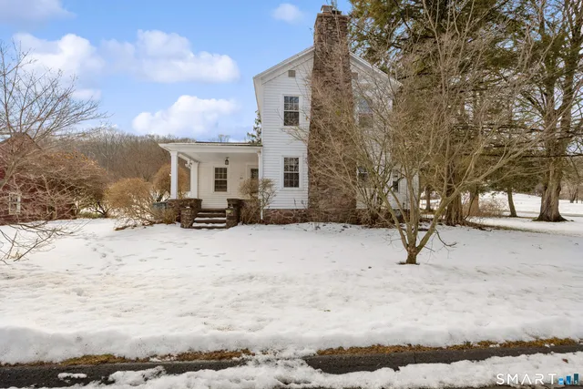 a view of a house with a snow in the yard