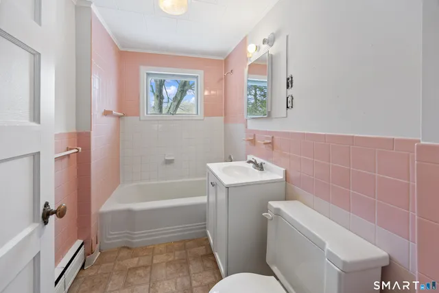 a bathroom with a toilet sink and bathtub