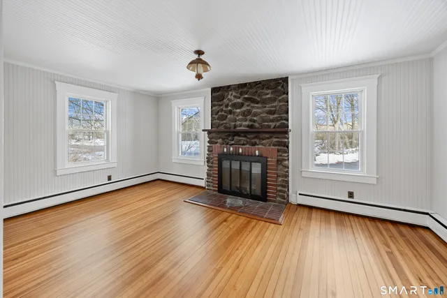 wooden floor in an empty room with a window