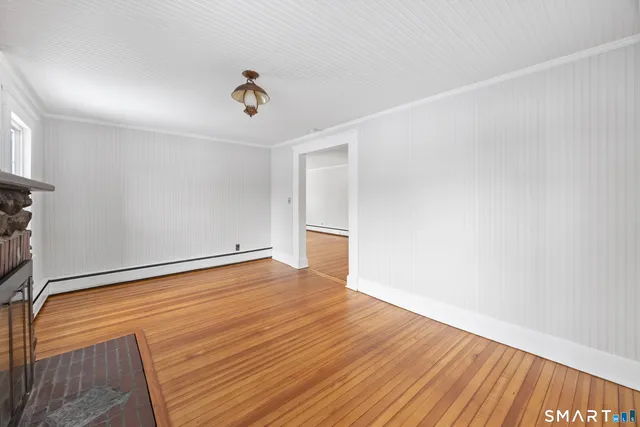 a view of a room with wooden floor and ceiling fan