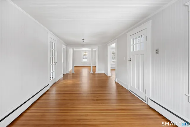 a view of an empty room with wooden floor