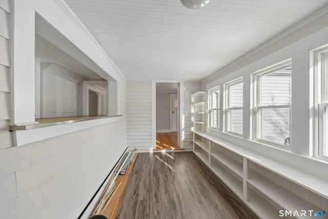 a view of a room with wooden floor and windows