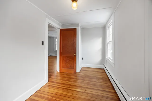 a view of a hallway with wooden floor