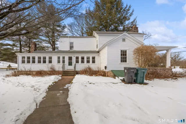 a view of a house with snow on the road