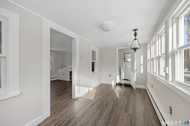 a view of a room with wooden floor and a window