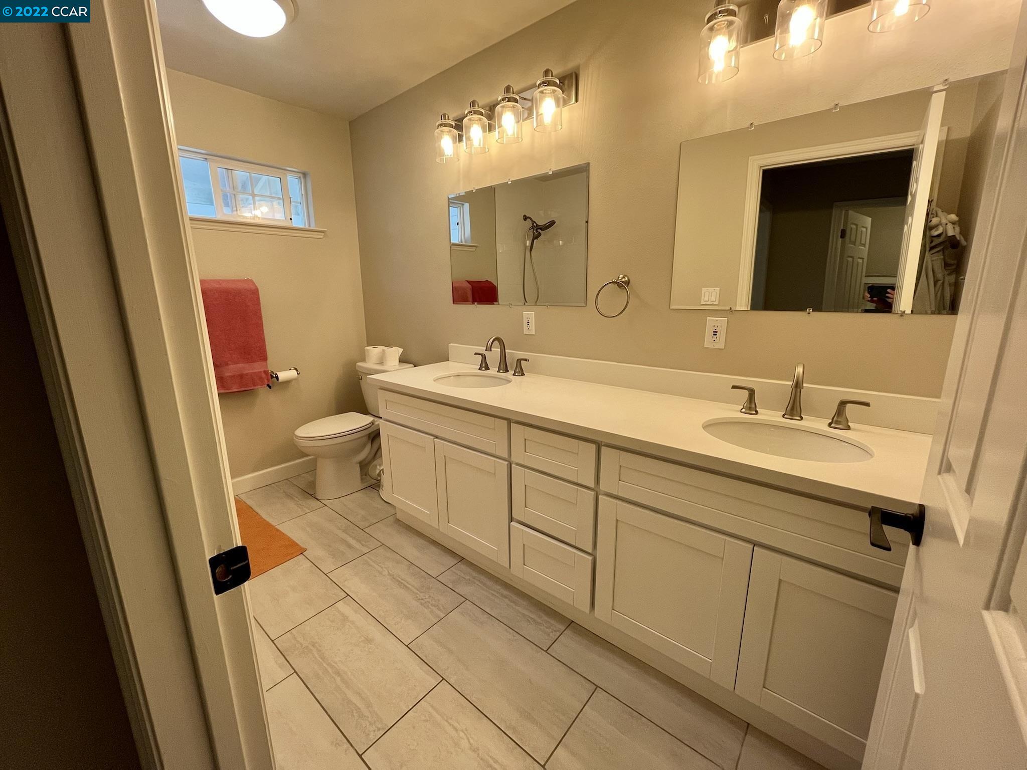 4387 Fallbrook Road Concord, CA 94521 - Photo 17 of 26 a bathroom with a sink a toilet and a mirror