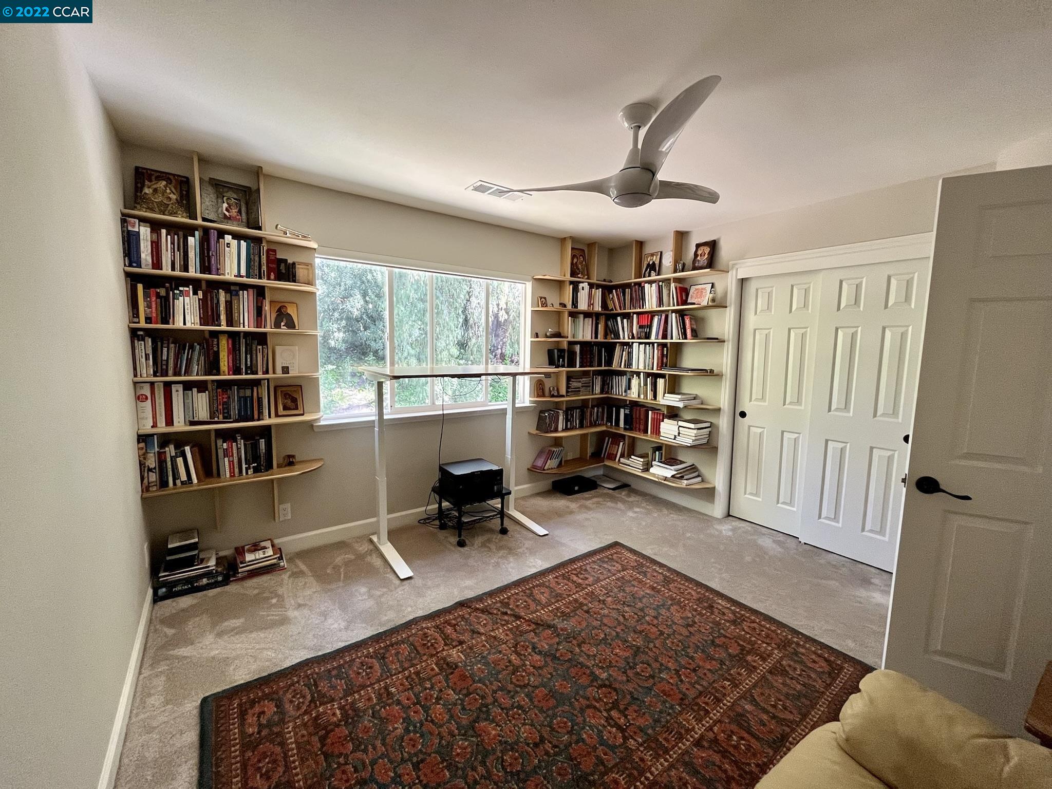 4387 Fallbrook Road Concord, CA 94521 - Photo 18 of 26 a living room with a book shelf and a book shelf