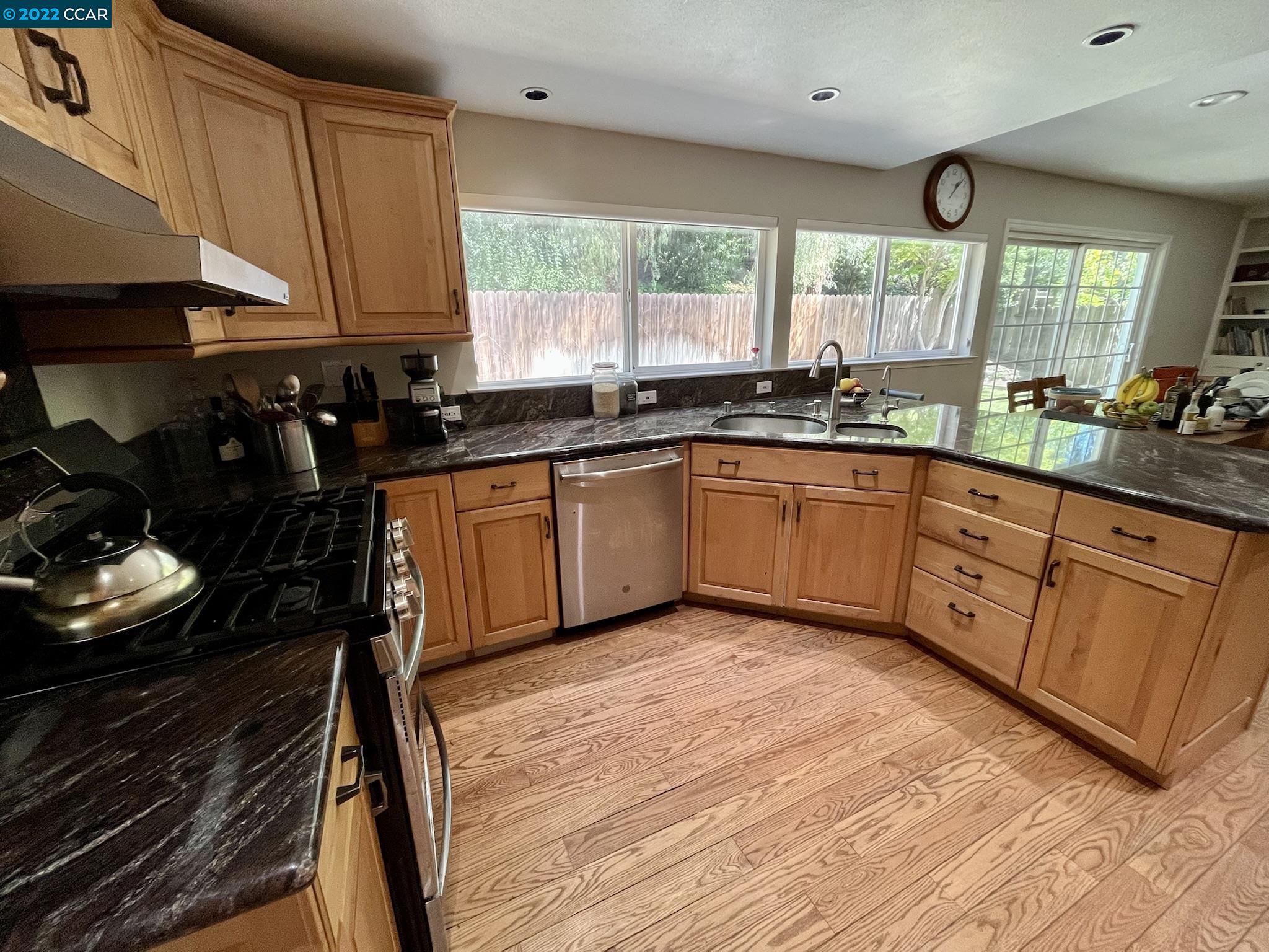 4387 Fallbrook Road Concord, CA 94521 - Photo 5 of 26 a kitchen with wooden cabinets a sink and a stove