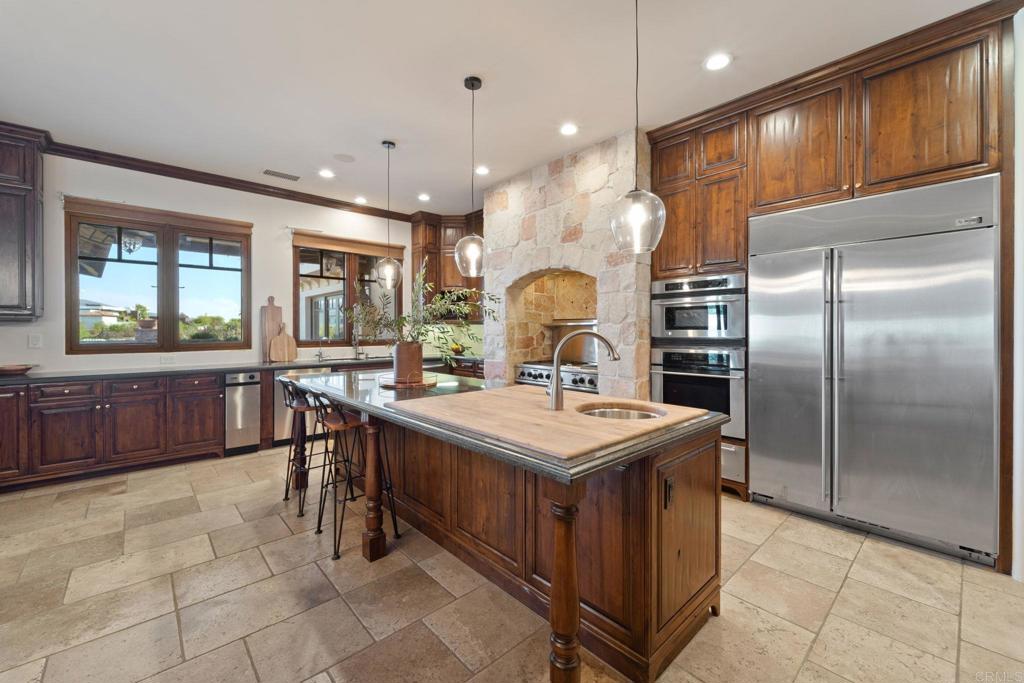 2908 Gate 5 Place Chula Vista, CA 91914 - Photo 24 of 63 a kitchen with a sink a counter top space stainless steel appliances and a window