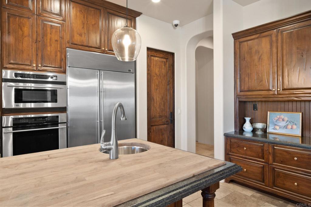 2908 Gate 5 Place Chula Vista, CA 91914 - Photo 25 of 63 a kitchen with stainless steel appliances granite countertop a refrigerator and a stove top oven