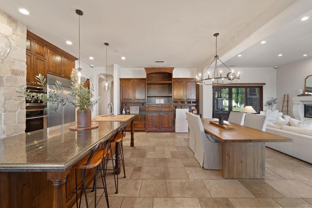 2908 Gate 5 Place Chula Vista, CA 91914 - Photo 30 of 63 a kitchen with stainless steel appliances granite countertop a sink a stove and a wooden floors