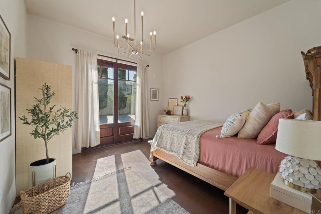 2908 Gate 5 Place Chula Vista, CA 91914 - Photo 41 of 63 a bedroom with a large bed and a chandelier