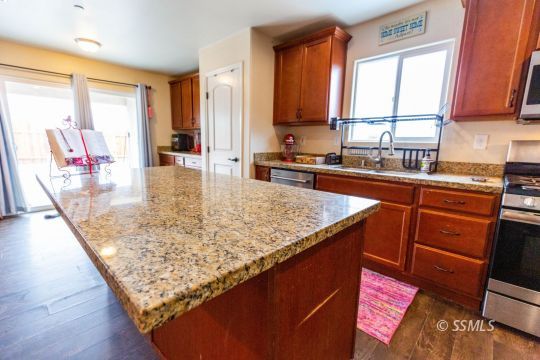 913 South McCall Street Ridgecrest, CA 93555 - Photo 7 of 40 a kitchen with kitchen island granite countertop wooden cabinets and a granite counter tops