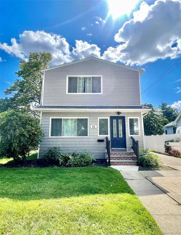 a front view of a house with a garden and yard
